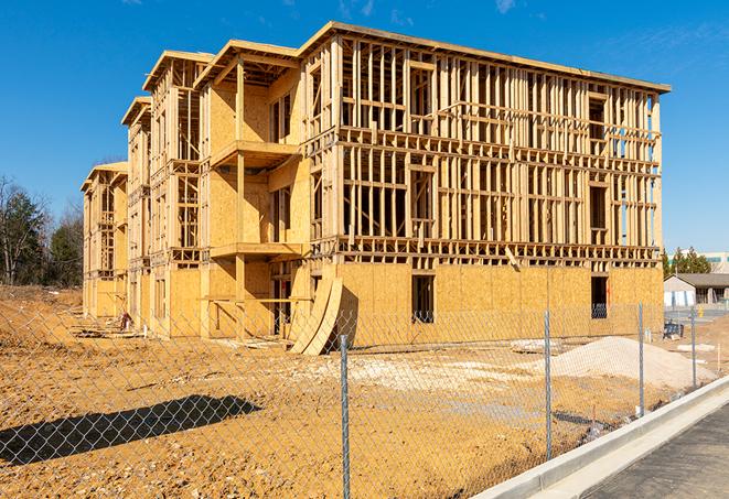 a panoramic view of temporary chain link fences on a job site, separating work zones in Kettleman City CA